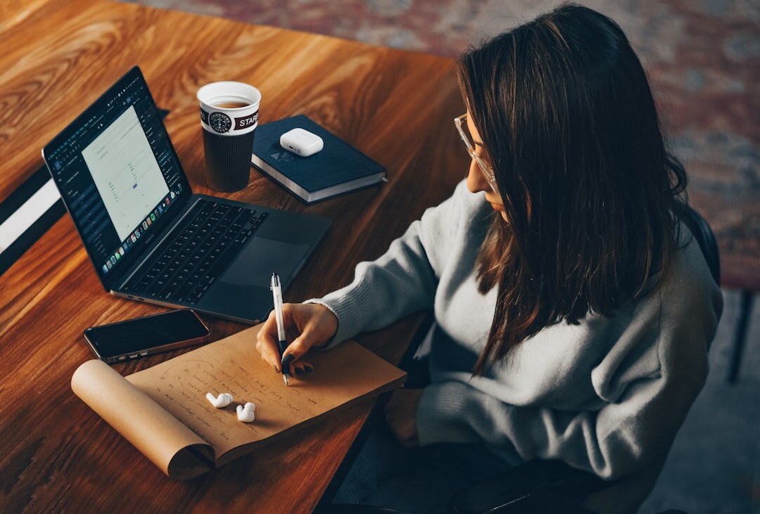 Person taking notes while on a video call